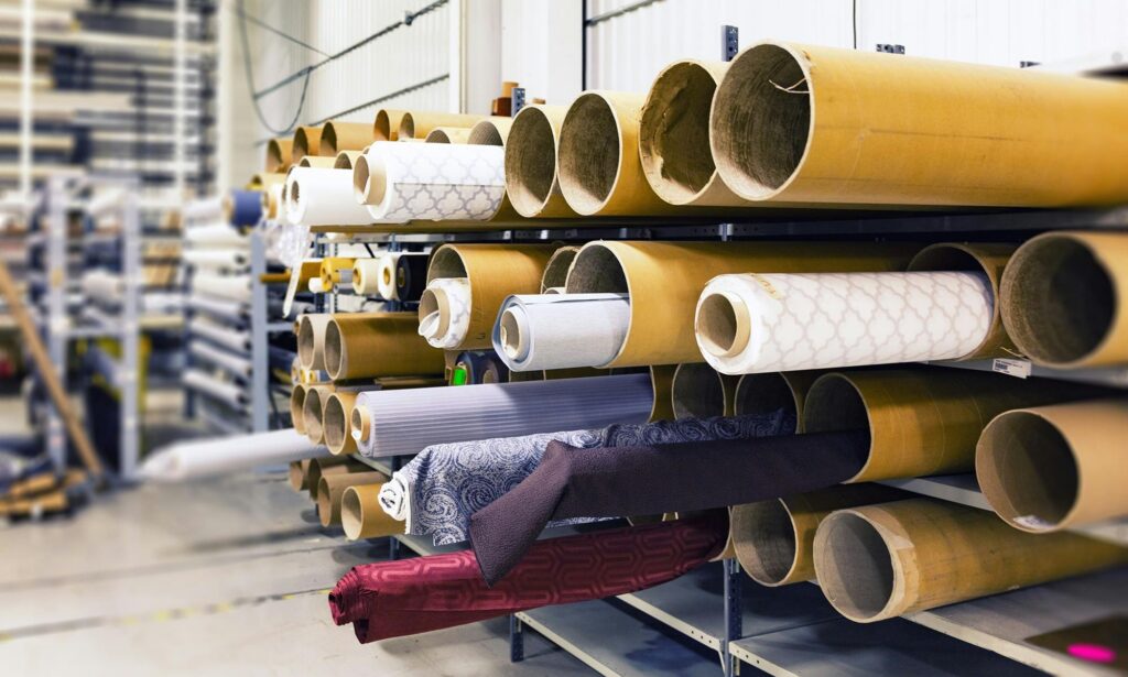 Rolls of paper stacked in an industrial warehouse